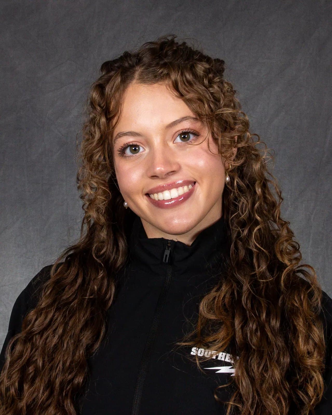 Official Southern Utah roster headshot of gymnast Berlin Hall in a black Southern Utah jacket.