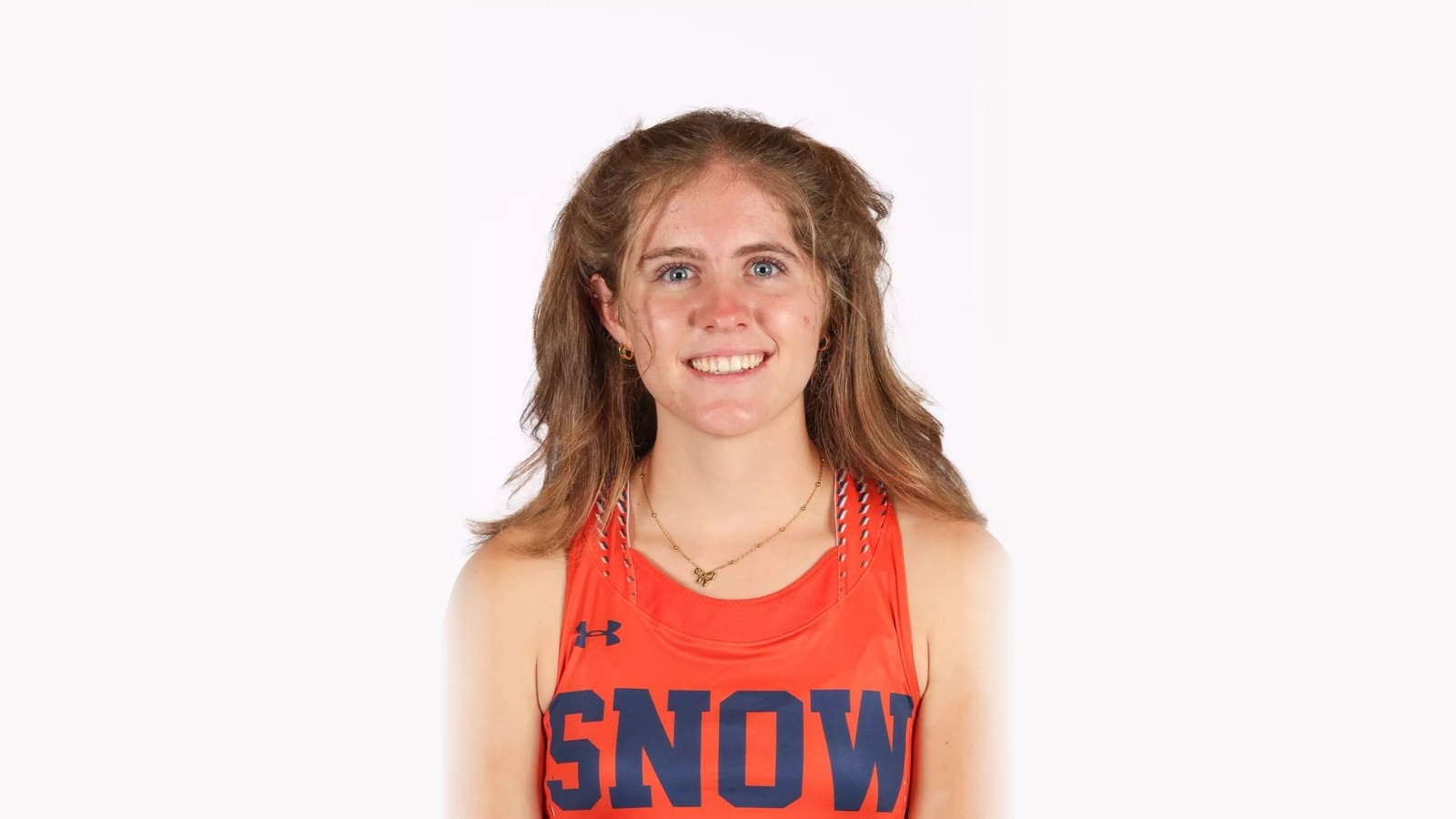 Skye Siddoway smiling in an orange Snow College cross country singlet in her official 2026-27 roster headshot.