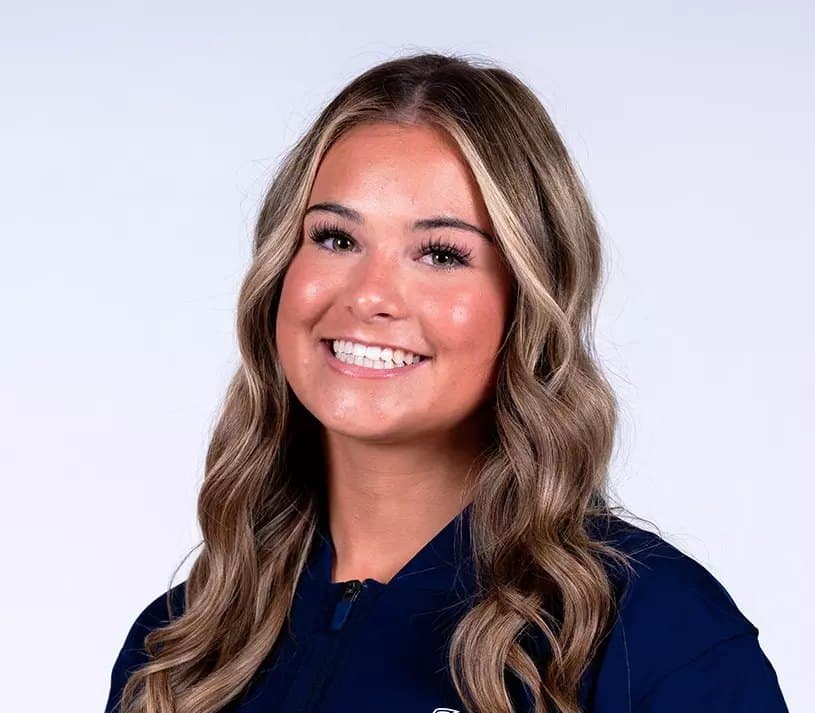 Official Utah State roster headshot of gymnast Sydney Jelen in a navy Utah State jacket.